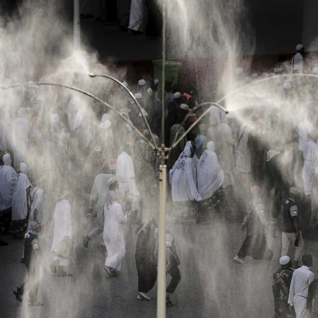 Pilgrims receiving cooling mist support during Hajj season