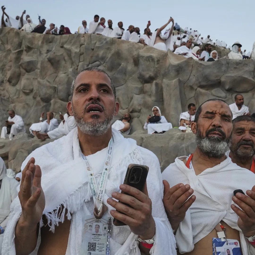 Pilgrims praying at Mount Arafat during Hajj spiritual preparation